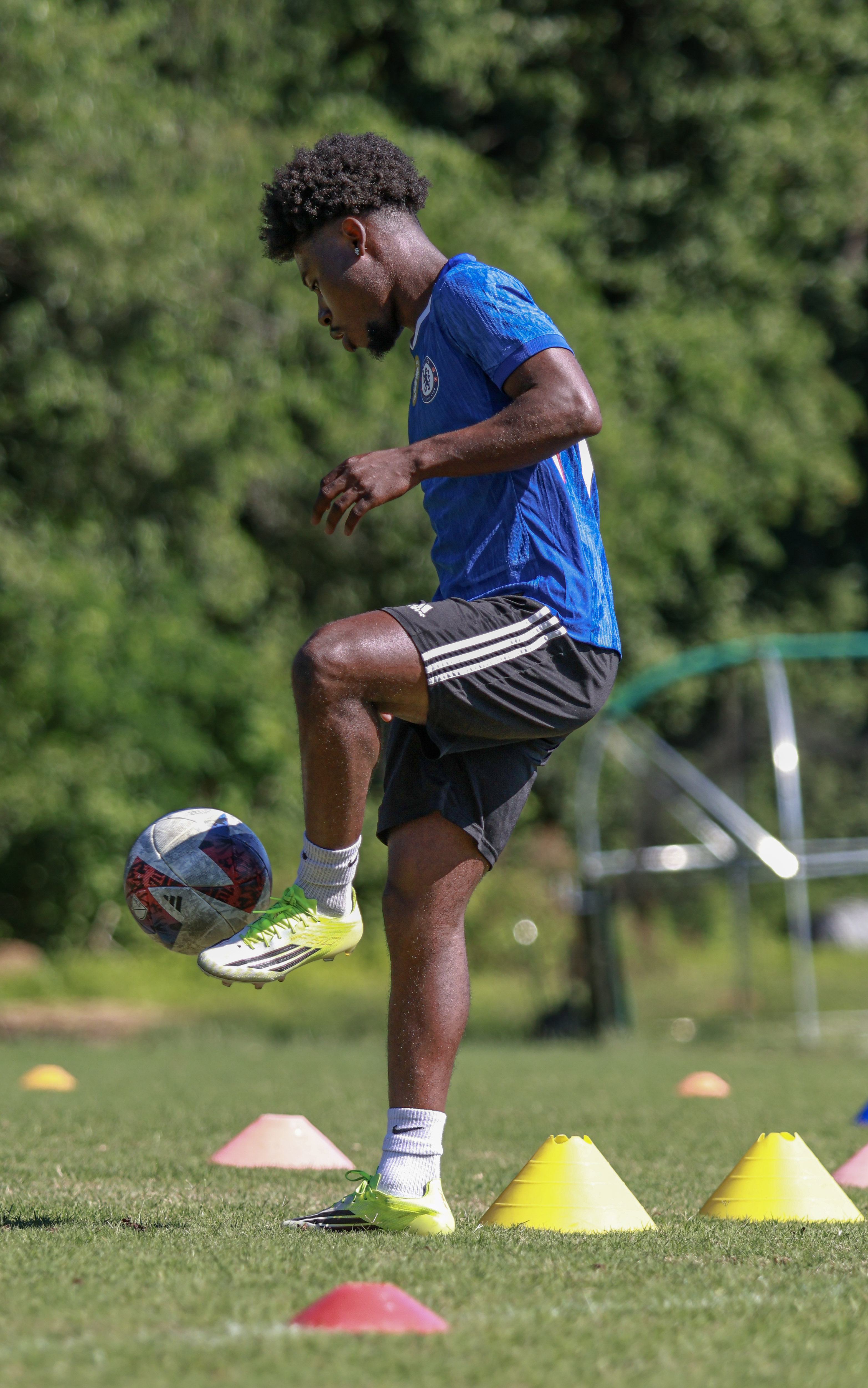 Soccer player works on honing his skills during training session.
